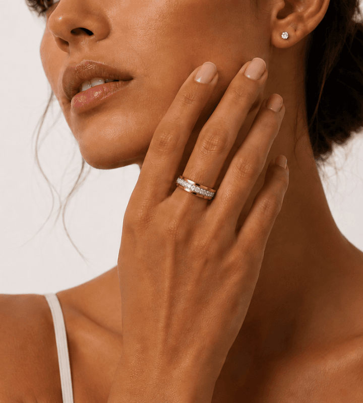 A woman wearing a BERLEV fine-jewelry ring, her ringed hand resting against her jaw