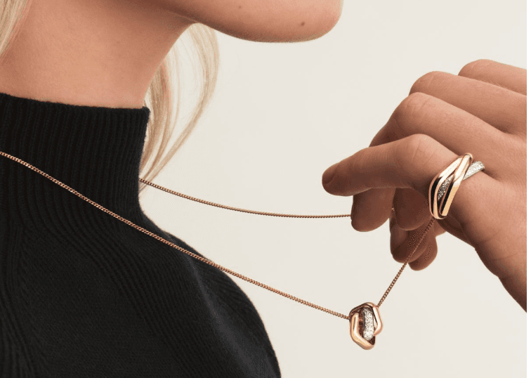 A hand wearing a fine gold BERLEV ring